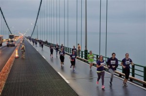 Runners lead the way across the Mackinac Bridge, Monday, Sept. 7, 2015, during the 58th annual Mackinac Bridge Walk, in Mackinaw City, Mich. Selected runners are allowed to precede the governor and 40,000 walkers who followed them across the span between Michigan's upper and lower peninsulas. (AP Photo/John L. Russell)