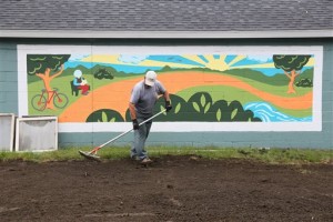 In this photo taken Wednesday, Sept. 9, 2015,  a workers prepares Riverview Launch for the grand opening. in Kalamazoo Mich. A grand opening for Riverview Launch, a former tax-foreclosed greenhouse property along the Kalamazoo River that has been redeveloped for public use, will be held Thursday, Sept. 10. (Mark Bugnaski/Kalamazoo Gazette-MLive Media Group via AP) ALL LOCAL TELEVISION OUT; LOCAL TELEVISION INTERNET OUT; MANDATORY CREDIT